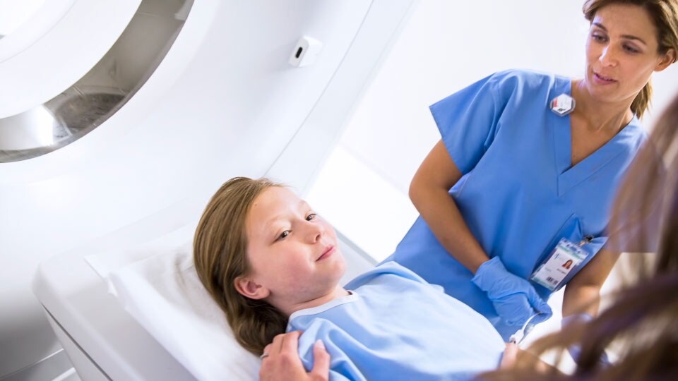 Photo of clinician and patient with spectral-detector CT system