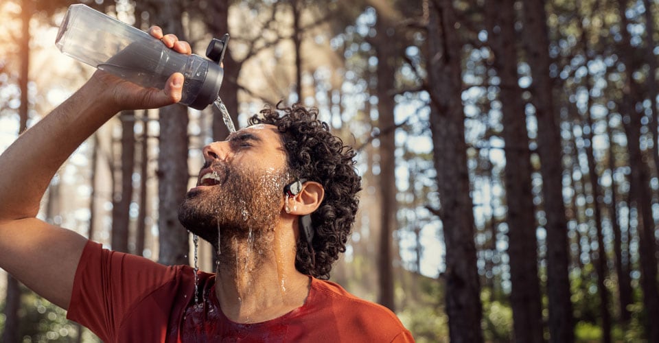 A man running outside with bone conduction headphones