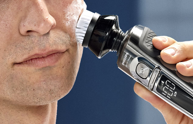Close-up van een man met zeer korte stoppels die een Philips OneBlade tegen zijn wang drukt.
