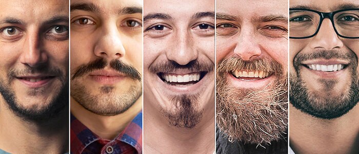 Collage van portretten van zeven mannen met verschillende baardstijlen die naar de camera kijken en glimlachen.