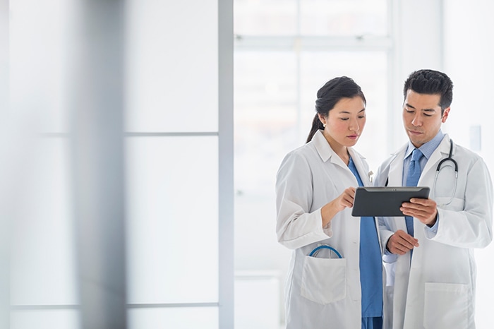 Clinicians view patient data on tablet