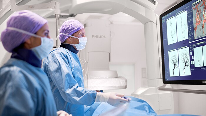 An interventional physician assesses a stroke patient on the Philips Azurion image-guided therapy platform