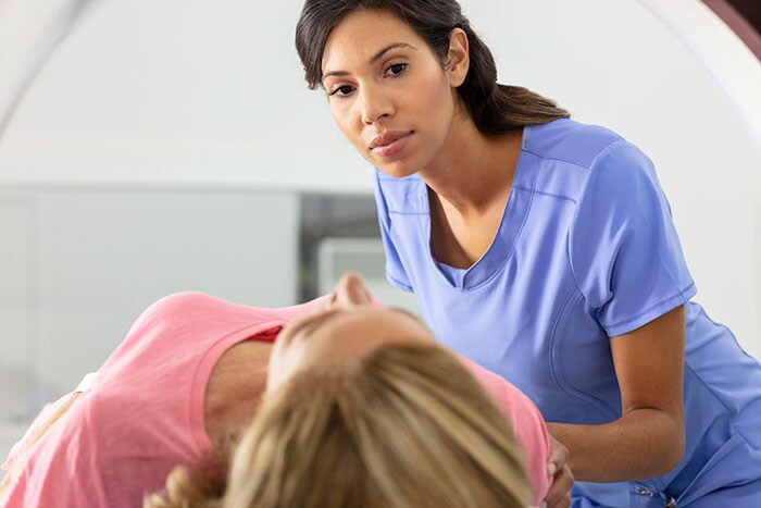 Radiology technologist guides patient